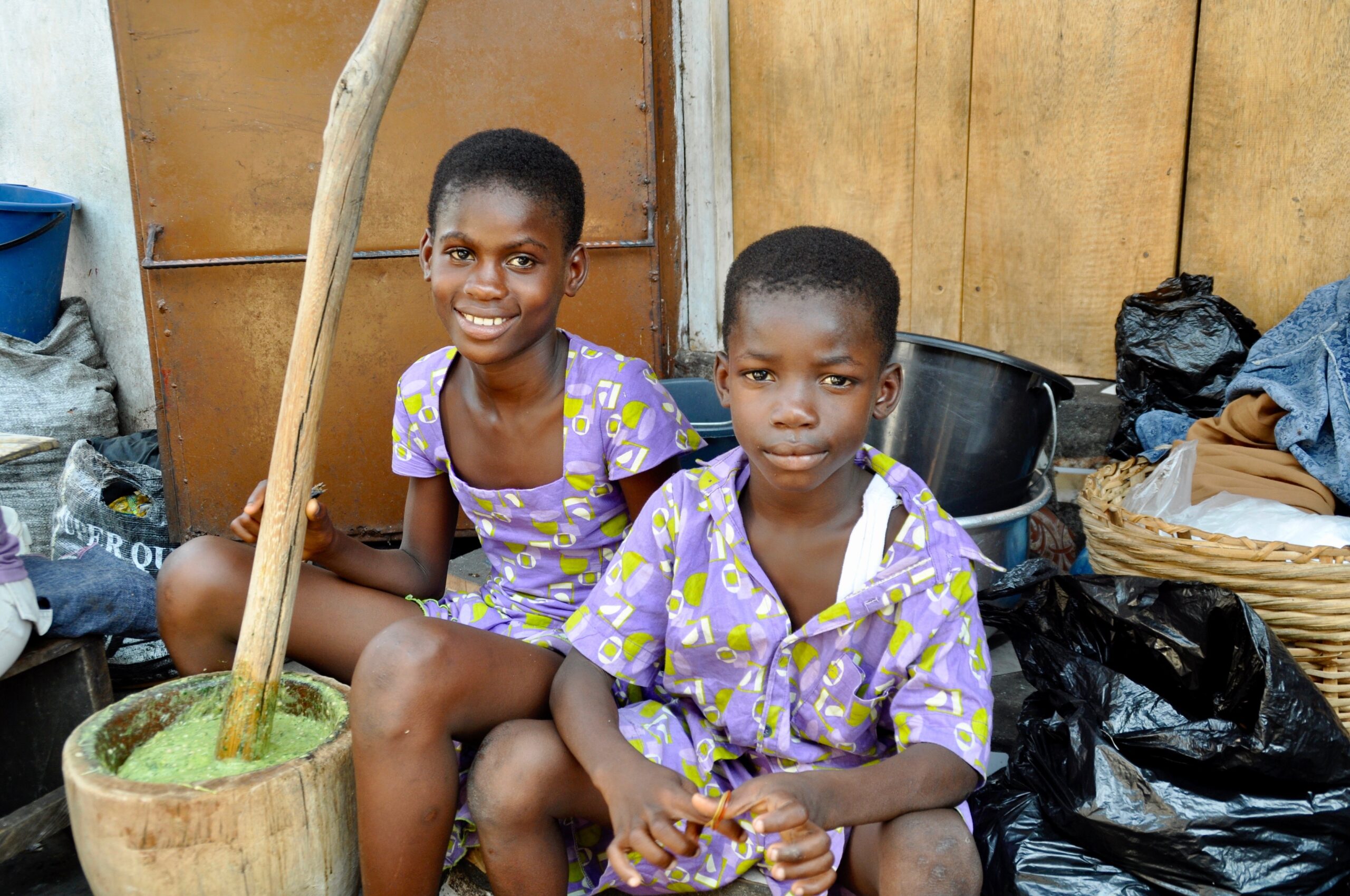 african siblings prepare food